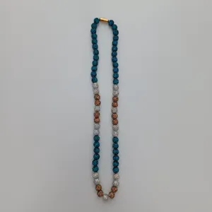 Detailed close-up of blue, bronze, and silver rhinestone Shamballa bead necklace item.