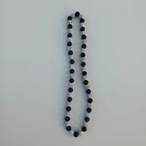 Detailed view of the sparkling black and white rhinestone Shamballa beaded necklace.