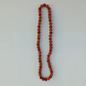 Close-up detail shot of the glittering red and gold rhinestone shamballa beads necklace.