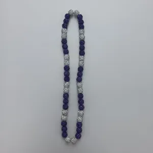 Detailed view of the purple and silver rhinestone disco ball beaded necklace, close-up.