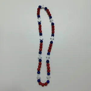 Detail view of the red and blue rhinestone shamballa bead necklace featuring white cross spacers.
