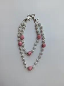 Detailed view of 12mm pink and white rhinestone clay ball beads on a hip hop pants chain