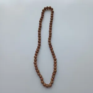 Bronze rhinestone clay bead necklace detail, sparkling crystal ball pendant close-up view.