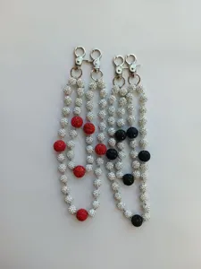 Close-up of 12mm rhinestone disco ball bead chains for pants and bags in red and black.