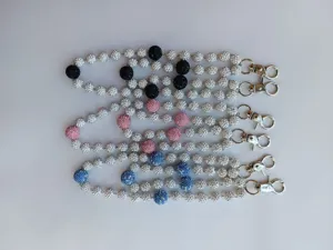 Detailed view of three 12mm rhinestone clay ball chains with metal clasps