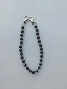 Close-up of a 12mm black rhinestone bead chain with silver lobster clasps