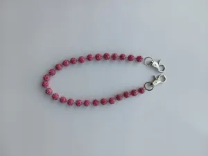 Detail of 12mm pink rhinestone disco ball chain strap with dual silver lobster clasps