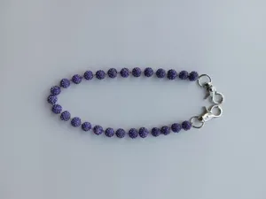Close-up of 12mm purple rhinestone disco ball beads and silver metal lobster clasps