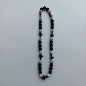 Close-up detail of the black and silver shamballa beaded necklace featuring cross accents.