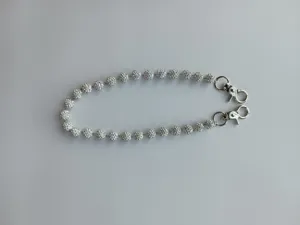 Close-up of 12mm white clay disco ball trouser chain with silver lobster clasps