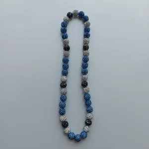 Close up detail view of sparkly blue silver and black rhinestone disco ball beads necklace.
