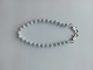 Detail view of 12mm white clay bead chain with iridescent rhinestones and lobster clasps.