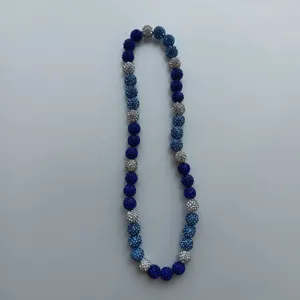Detail view of the blue and silver Shamballa rhinestone bead necklace close up shot.