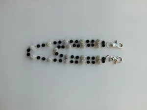 Close-up detail of a 12mm rhinestone pavé bead pants chain with black and white accents