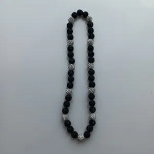 Black and silver Shamballa rhinestone clay bead necklace elastic design detail view.