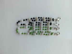Detailed view of 12mm clay rhinestone bead wallet chains in black and green styles.