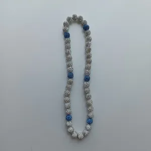Detailed view of rhinestone paved shamballa bead necklace in silver and blue sparkle design.