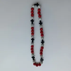 Close-up details of the red and silver rhinestone shamballa beaded necklace with black crosses.