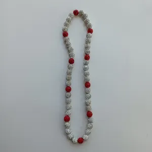 Detailed view of red and silver crystal rhinestone shamballa bead elastic necklace strand.