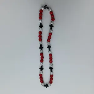 Detail view of Shamballa-style red and silver rhinestone beads necklace with black cross charms.
