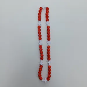 Red rhinestone clay bead necklace detail view with white cross spacers for hip hop street style.
