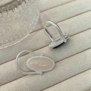 Detail view of silver wire wrapped ring featuring reversible black onyx and agate stone