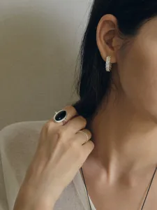Detailed shot of vintage silver ring with black agate stone on an Asian model's hand