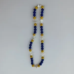 Blue and gold Shamballa rhinestone clay beads necklace with silver crosses detailed view.