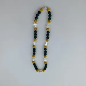 Detailed view of hip-hop cross necklace with sparkling crystal beads and metal cross charms.