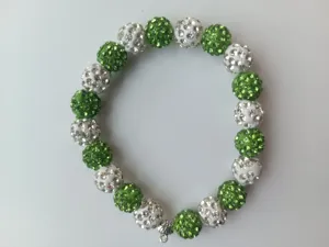 Green and white crystal rhinestone clay ball stretch bracelet detail view, elegant shine.