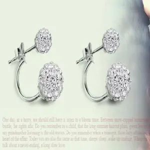 Close-up detail of silver-plated double Shamballa ball earrings with white crystal pave
