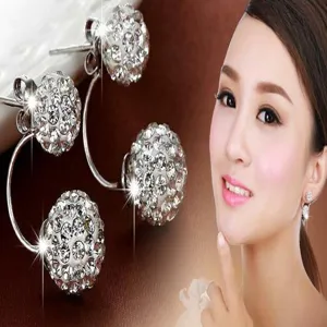 Close-up detail of sparkling white Shamballa crystal ball stud earrings on a model