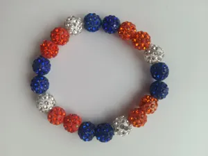 Close-up detail of a 10mm clay disco ball bead baseball bracelet in red, white, and blue colors