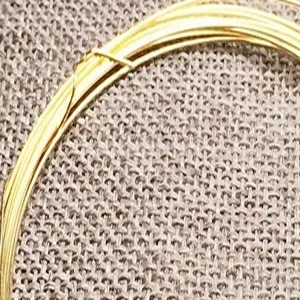 Close-up of 14k gold filled jewelry wire for DIY necklace and bracelet crafting.