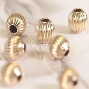 Detailed shot of 14k gold plated copper melon spacer beads for DIY jewelry making crafts.