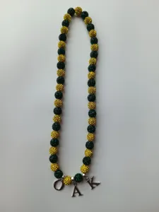 Green and yellow Shamballa rhinestone bead necklace featuring silver OAK letter charms