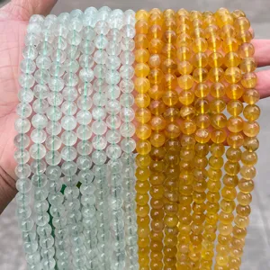 Detailed macro view of natural green and amber yellow fluorite loose beads for jewelry DIY