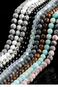 Detailed macro view of assorted frosted natural stone round beads for DIY jewelry making