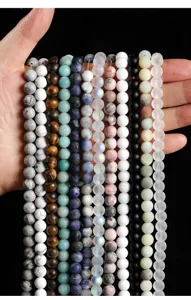 Macro detail view of various colorful frosted natural stone round beads for DIY jewelry.