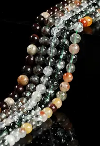 Detailed macro view of natural phantom quartz beads with unique green and red inclusions.