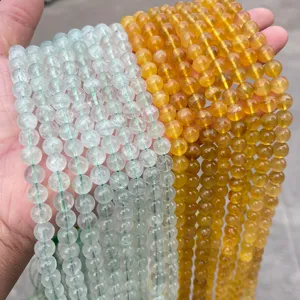 Macro view of natural yellow and green fluorite round beads for DIY jewelry making