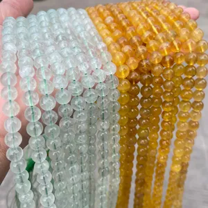 Macro view of translucent pale green and honey yellow fluorite beads for DIY jewelry