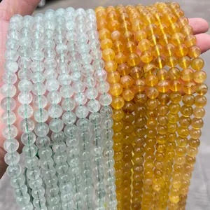 Detail view of natural yellow and green fluorite loose beads for DIY jewelry making.