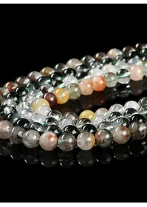 Close-up of natural phantom quartz beads showing unique green mineral inclusions for DIY