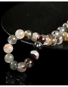 Close-up of natural phantom quartz beads with colorful inclusions for DIY jewelry making