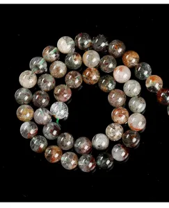 Close-up macro view of natural multi-colored phantom quartz round beads on black