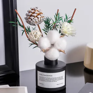 Aromatherapy reed diffuser set with black glass bottle and dried cotton flower decor for home.