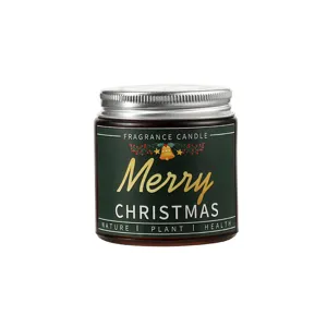 Christmas scented candle detail shot with green festive label and silver lid in glass jar.