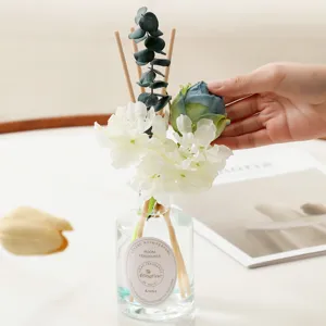 Reed diffuser set with glass bottle artificial flowers and scent sticks for home decor.