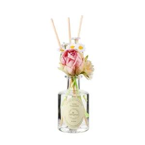 Elegant reed diffuser with artificial flowers and glass bottle, perfect for home fragrance decoration.